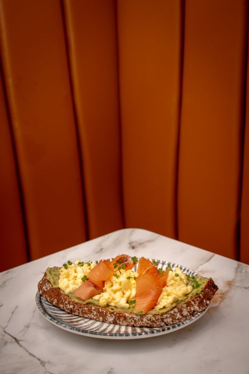 Free Delicious breakfast with scrambled eggs and smoked salmon on sourdough bread. Stock Photo