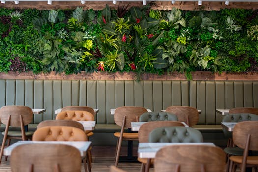 Contemporary indoor dining space featuring stylish seating and a vibrant vertical garden.
