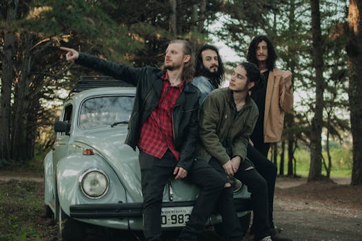 Four men posing with a vintage Volkswagen Beetle in a park setting, evoking a classic vibe.