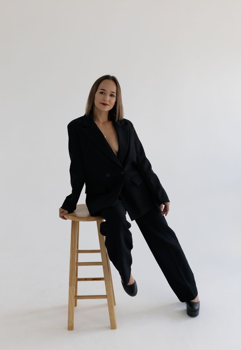 A Woman in Black Business attire Sitting on a Chair · Free Stock Photo