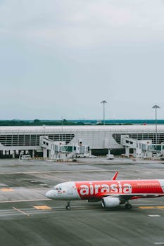 AirAsia airplane taxiing at Kuala Lumpur International Airport.