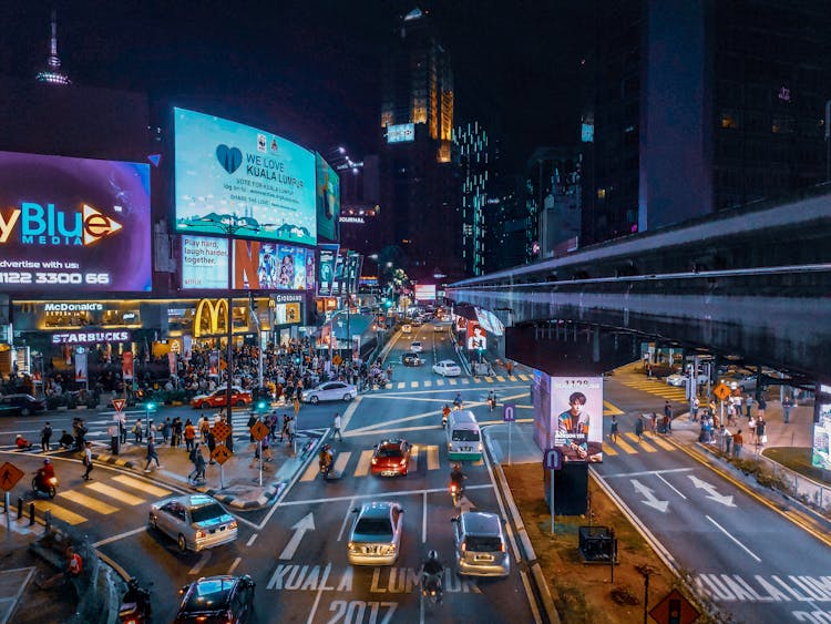 Aerial View Of People Walking On Street During Nighttime