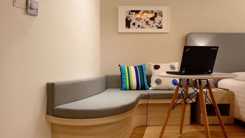 RV interior with a small printer and laptop on a fold-down table