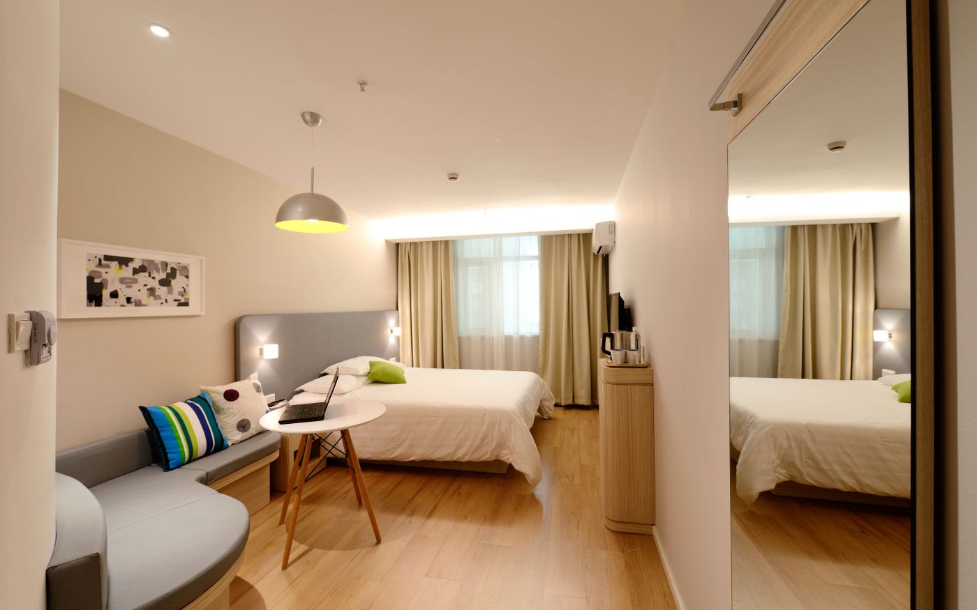 Modern condo bedroom with white linens and natural light Modern condo bedroom with white linens and natural light