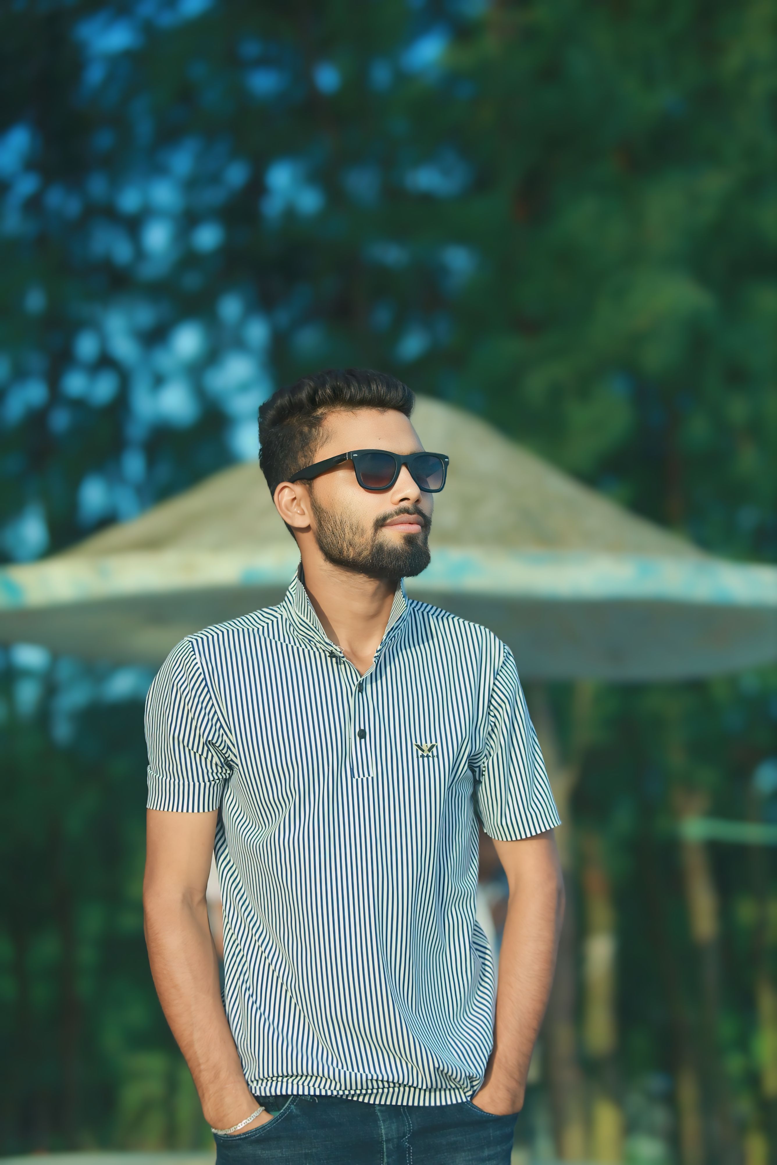 Casual portrait of a young man wearing sunglasses outdoors.