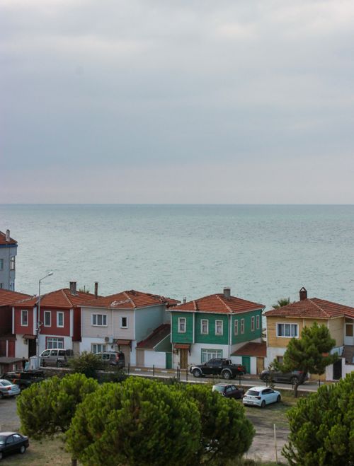 Free Scenic view of colorful houses by the sea showcasing vibrant rooftops against the ocean. Stock Photo