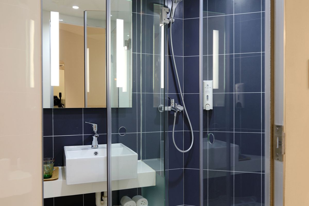 The Sioux Falls Bathroom Remodel Guide Walk-in shower with clear glass enclosure and modern tile