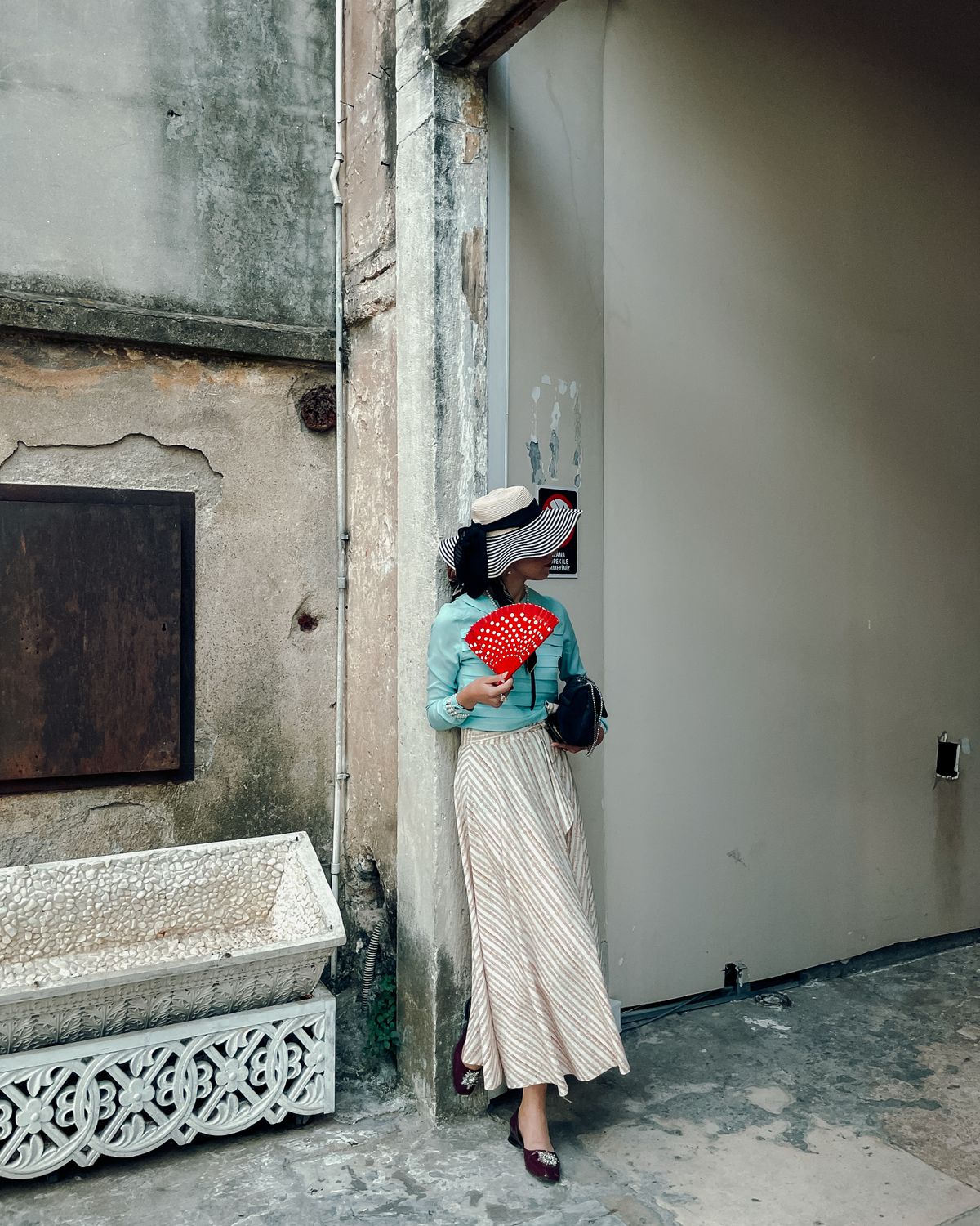 An elegant woman in classic Italian style standing in an archway