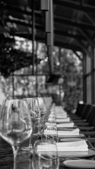 Long table with glassware and napkins in a stylish black and white theme.