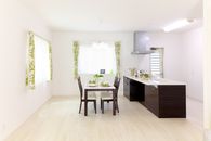 Sleek modern kitchen and dining area with natural light and minimalistic decor.