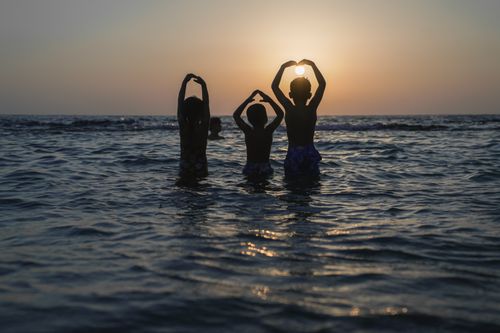 Free 3 Siblings playing in the Mediterranean sea. Stock Photo