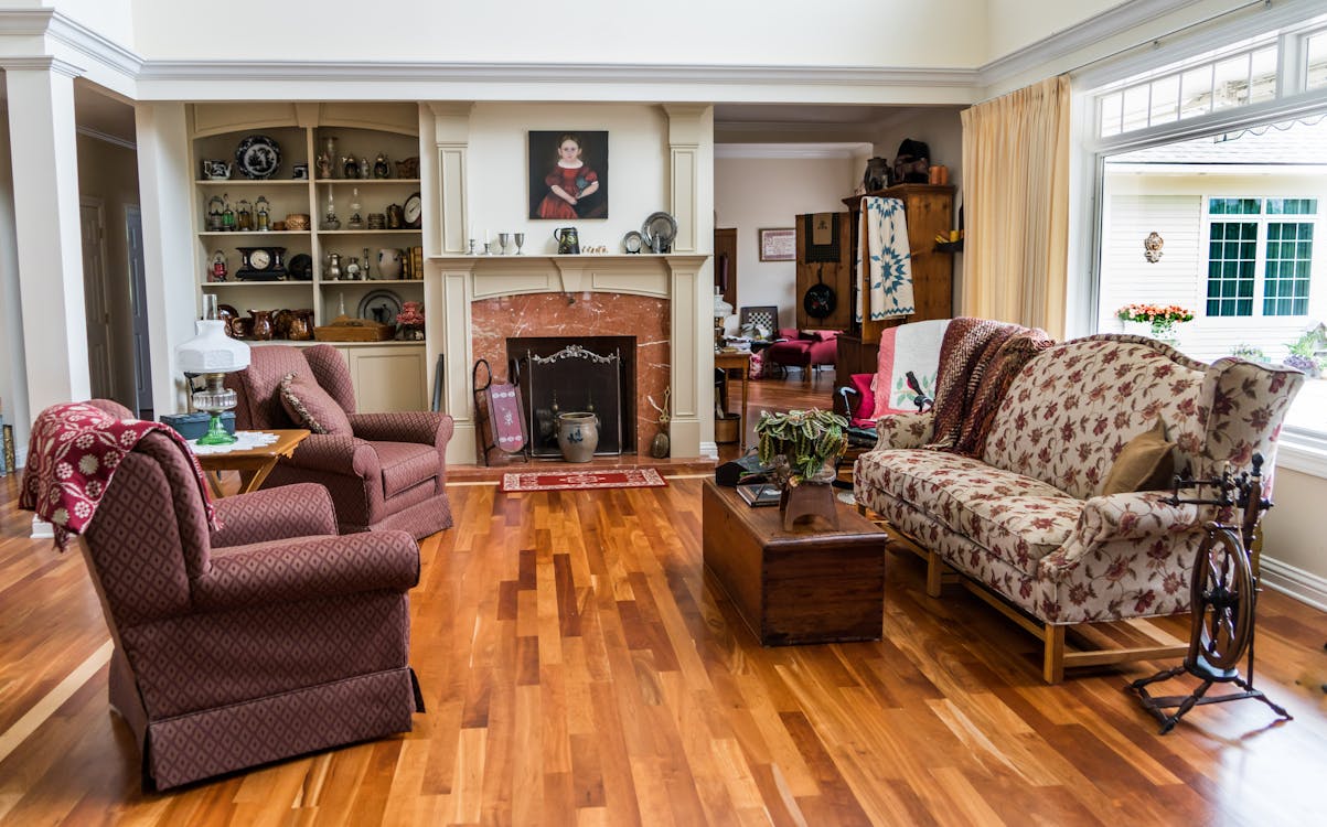 a traditional living room with a classic fireplace