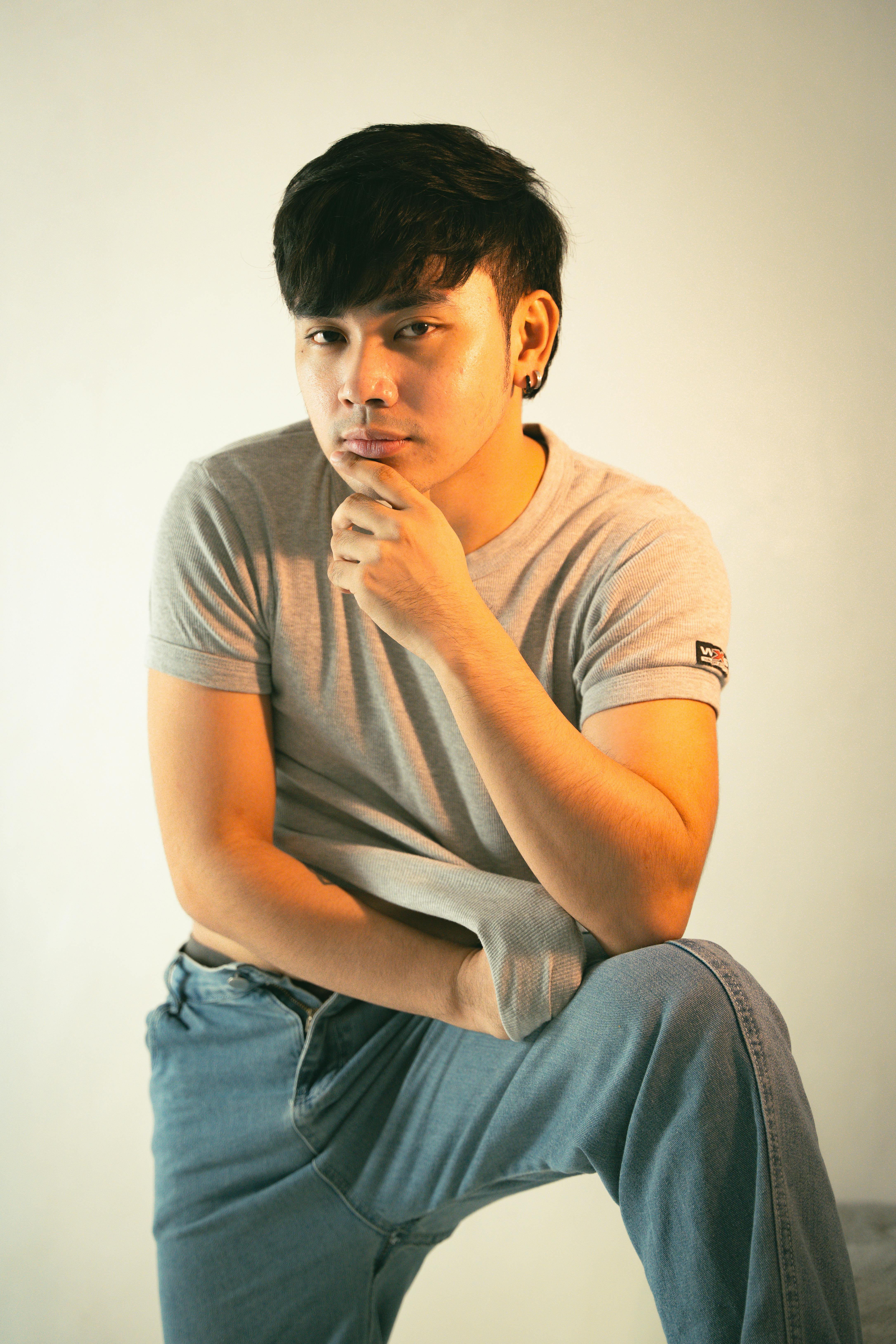 portrait of man wearing grey t shirt in golden light