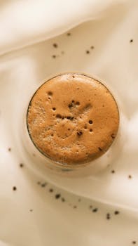 Top view of a frothy cappuccino with chocolate sprinkles, perfect for coffee lovers.