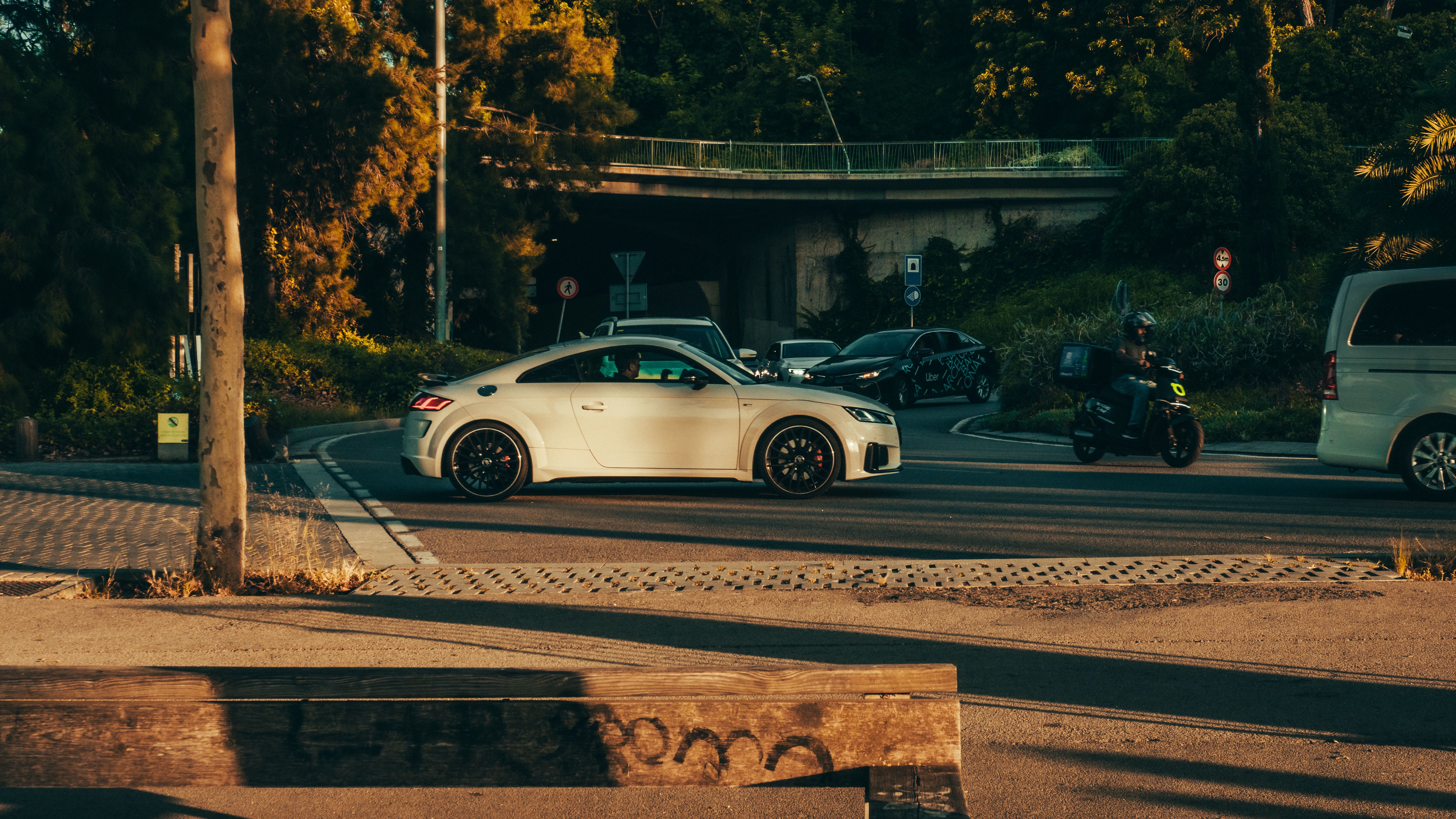 A white car is parked on the side of the road · Free Stock Photo