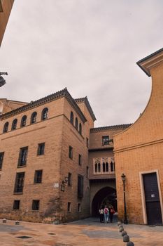 Captivating view of historic buildings under a cloudy sky in Zaragoza, Spain.