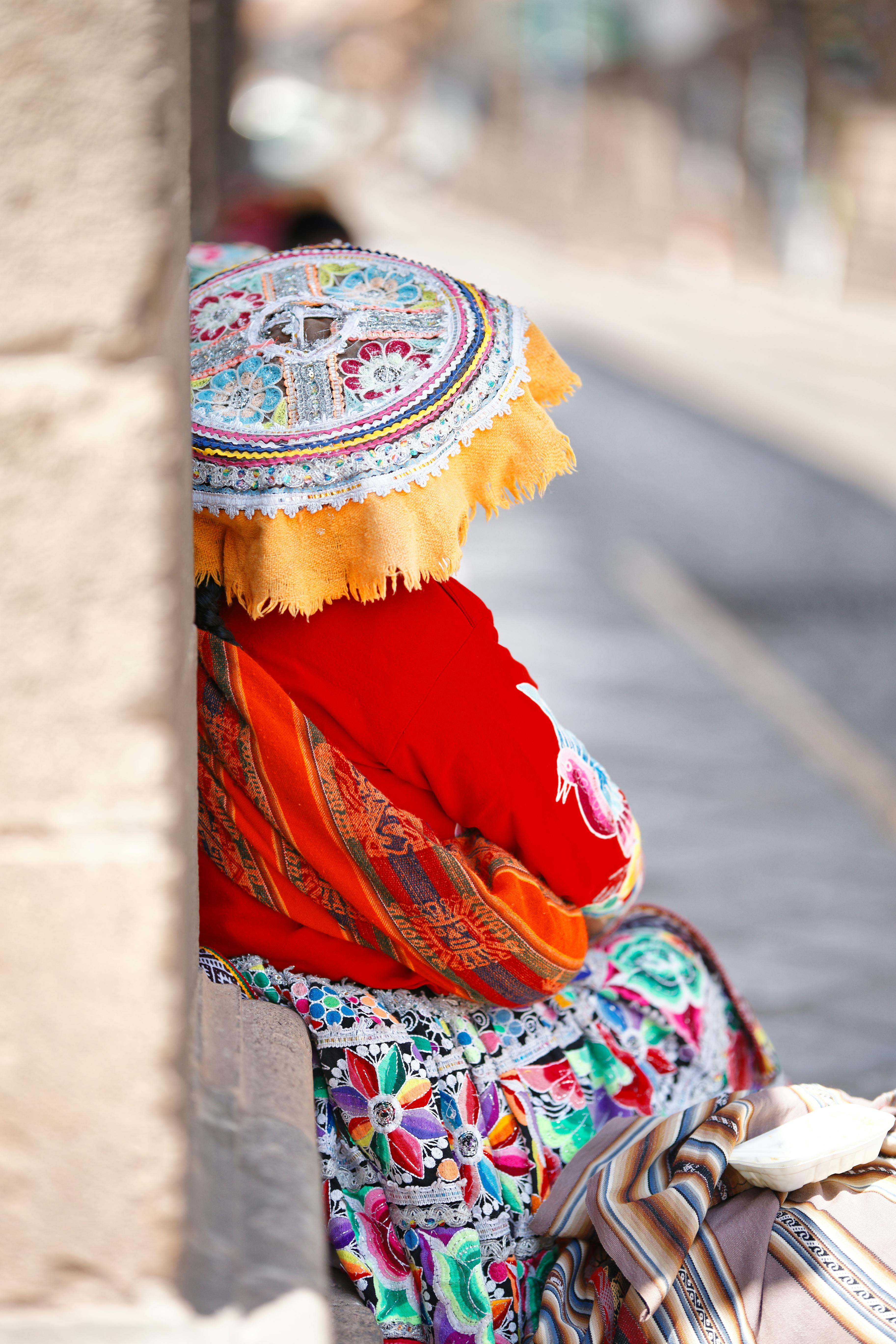 Vibrant traditional attire in a Cusco street, showcasing Andean cultural heritage.