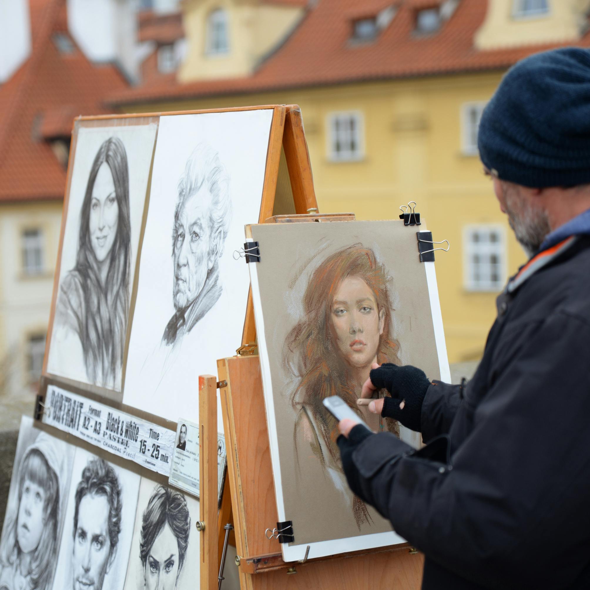 photo of man drawing a portrait of a woman