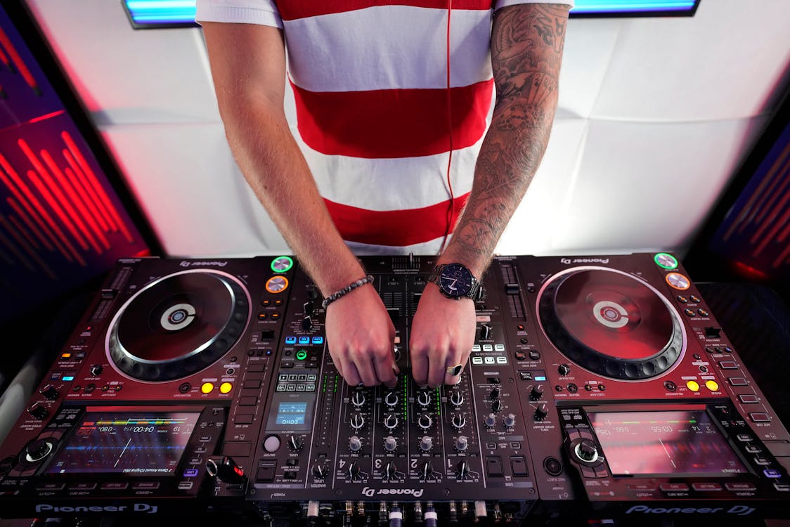 Free Person Using DJ Mixer Stock Photo