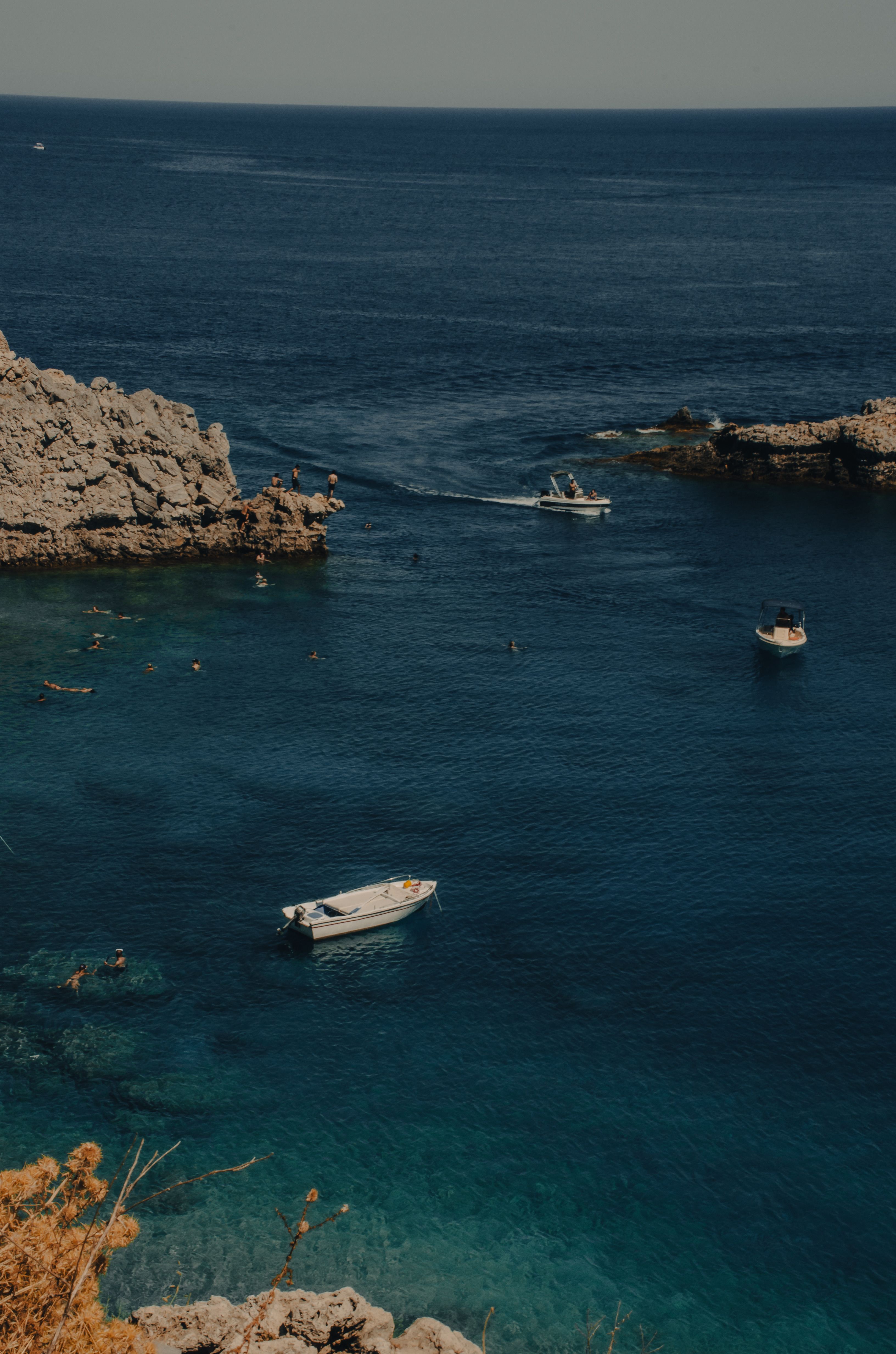 A boat is docked in the blue water · Free Stock Photo