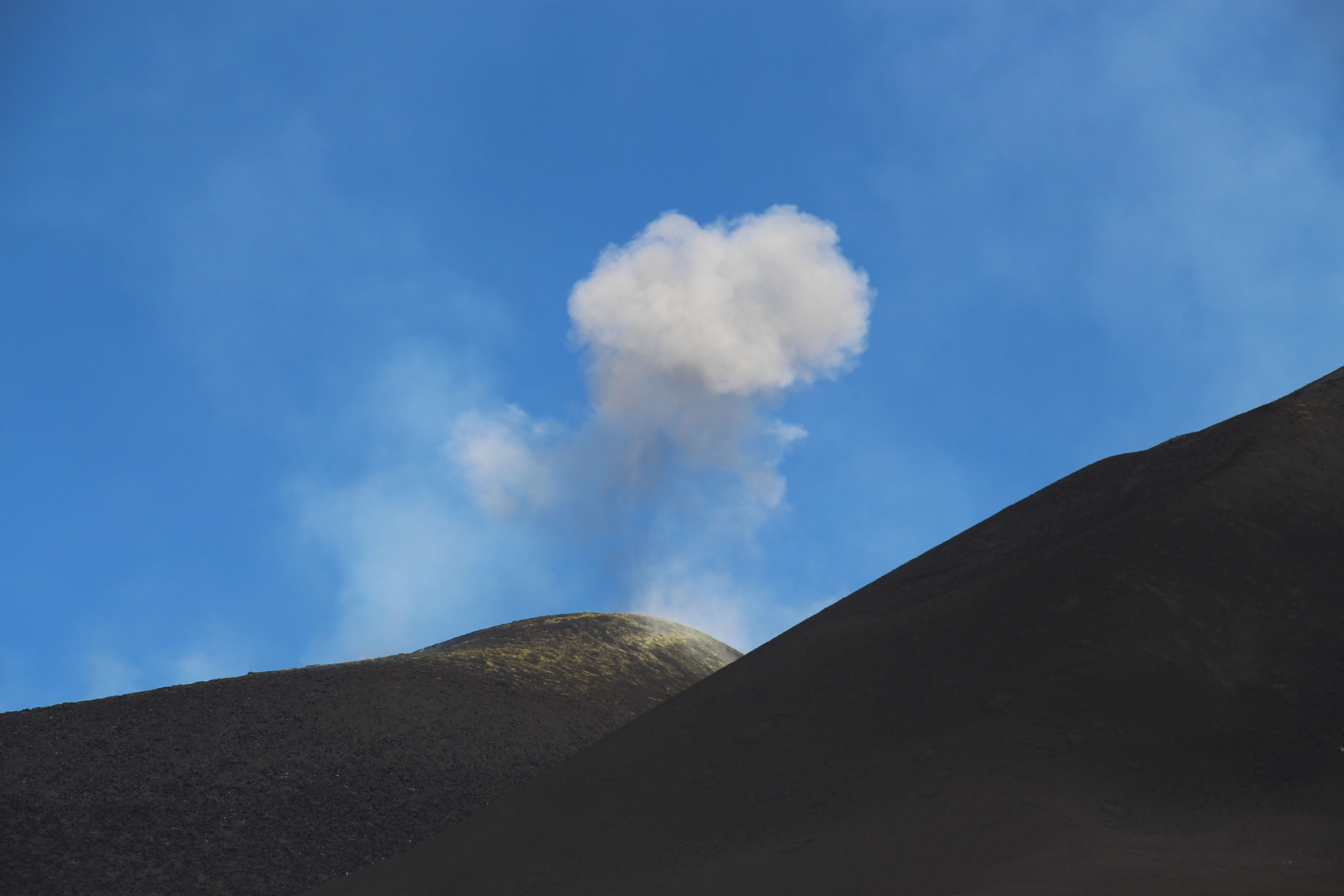 A volcano with smoke coming out of it · Free Stock Photo