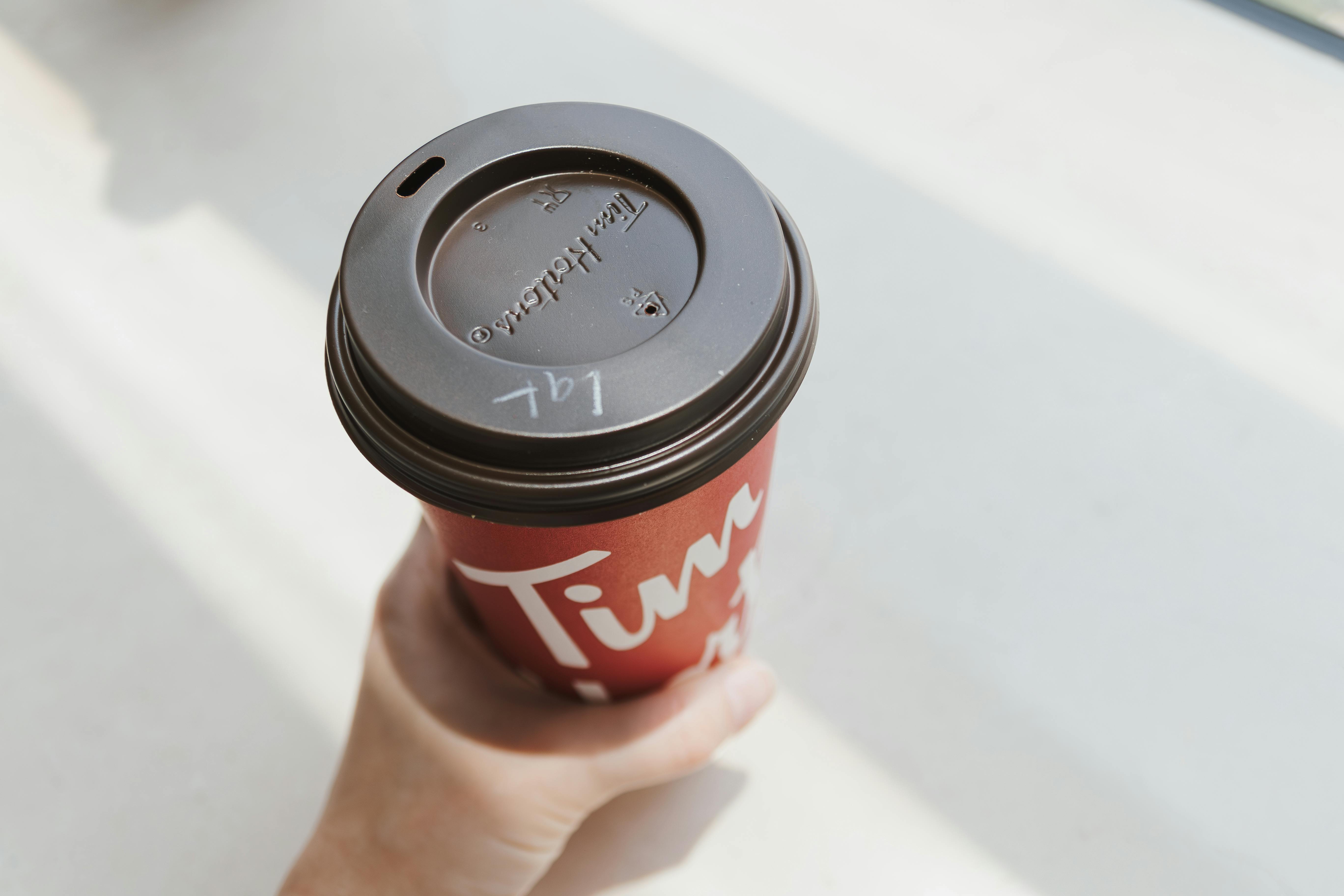 red coffee cup with morning light on white background