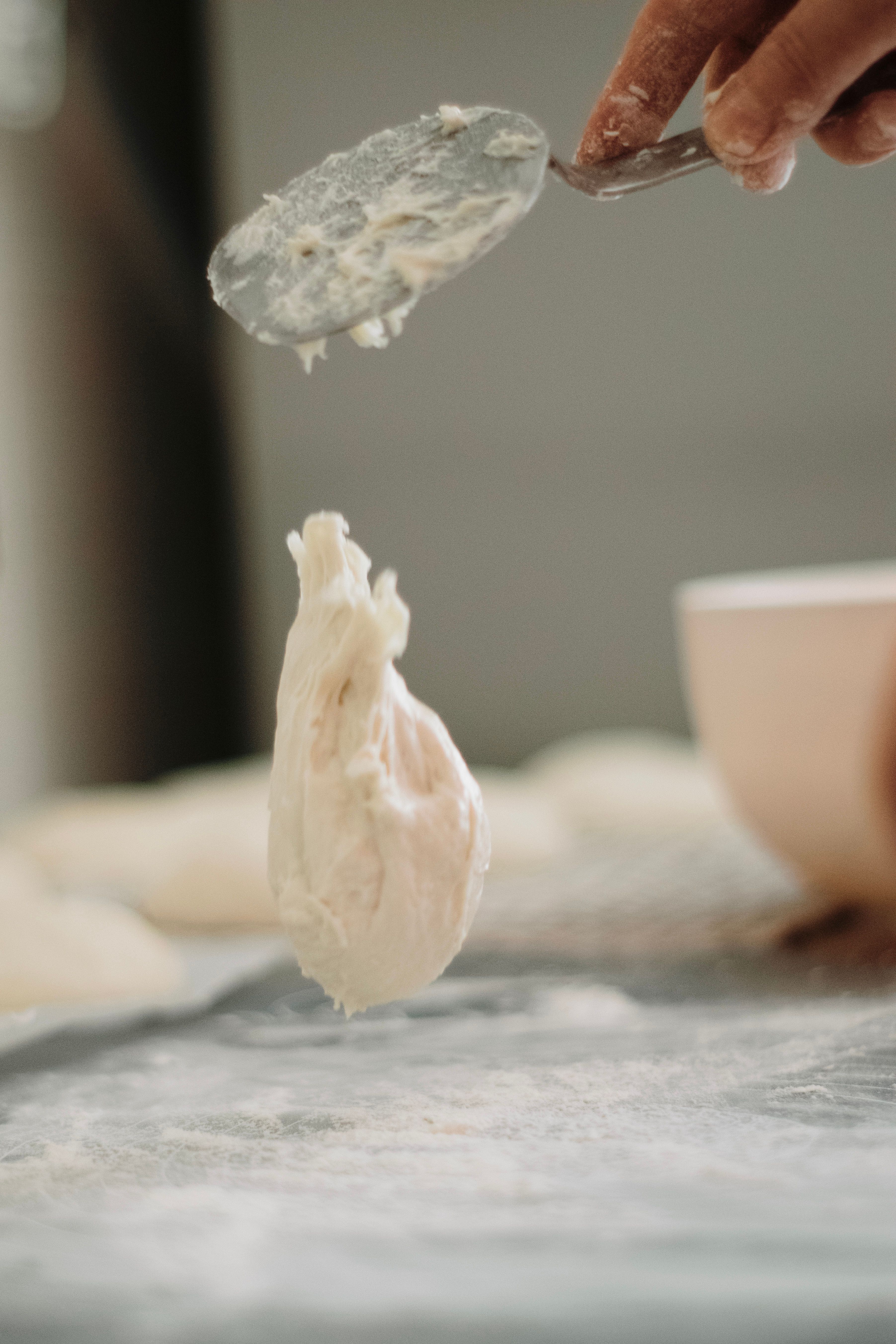 Close-up of dough being kneaded, showing the texture of hydrated flour and developing gluten network