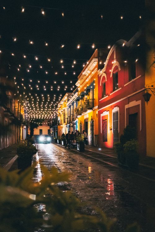 Free Illuminated street in Puebla, Mexico featuring colorful architecture and string lights at night. Stock Photo