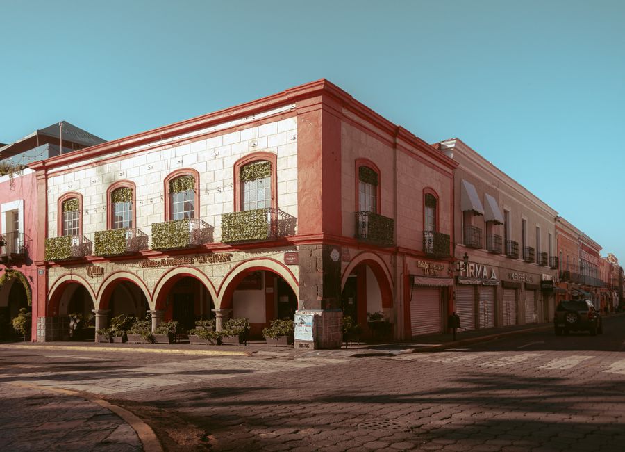 Colonial building facades in Atlixco, Mexico, showcasing warm hues and classic architecture.