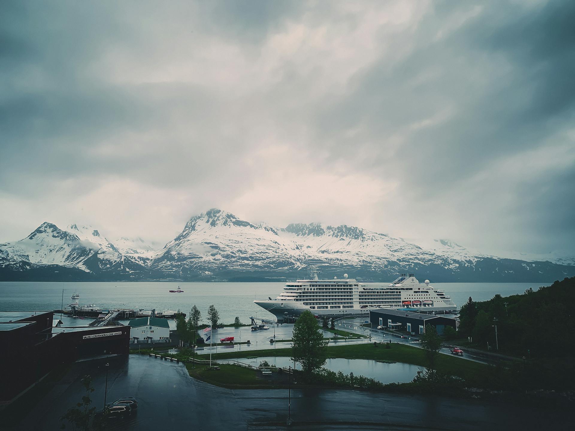 Cruise Ship Moored on Sea Coast near Mountains