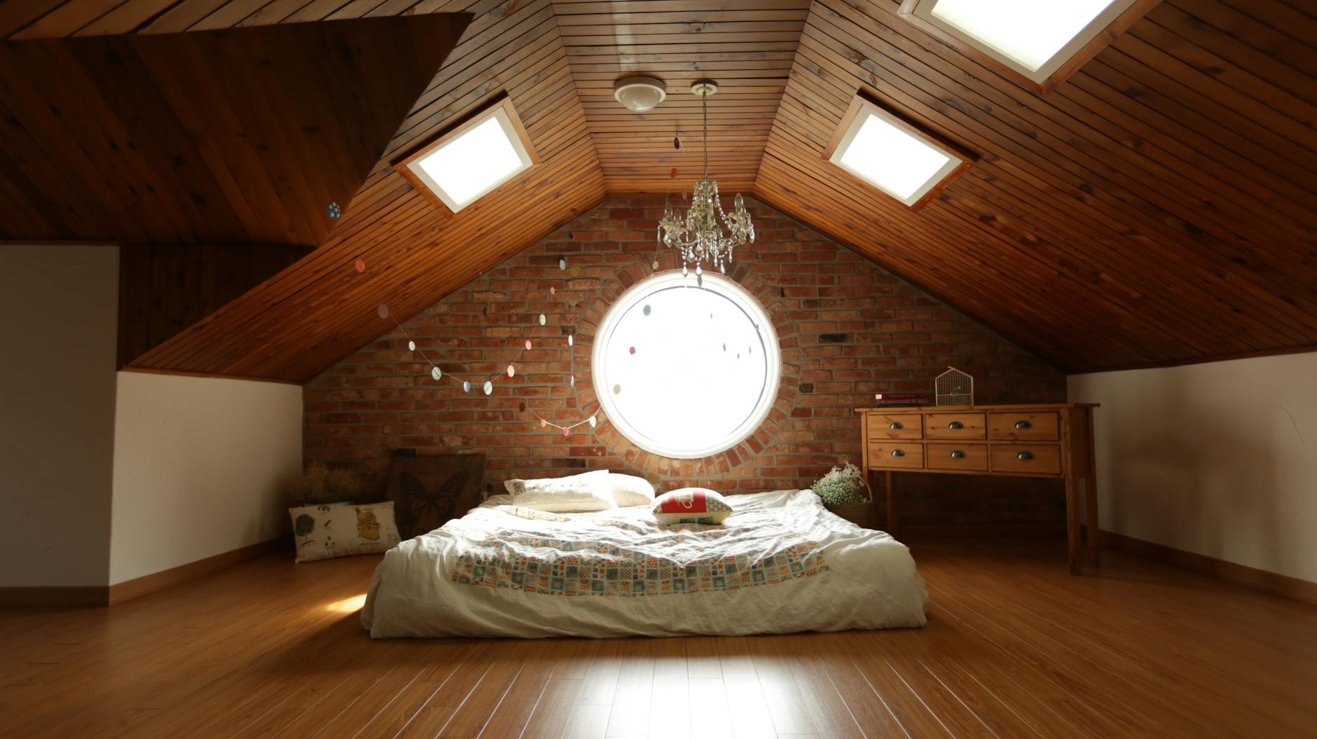 Modern Bedroom with Cozy Bed covered with Bed Sheets in Attic