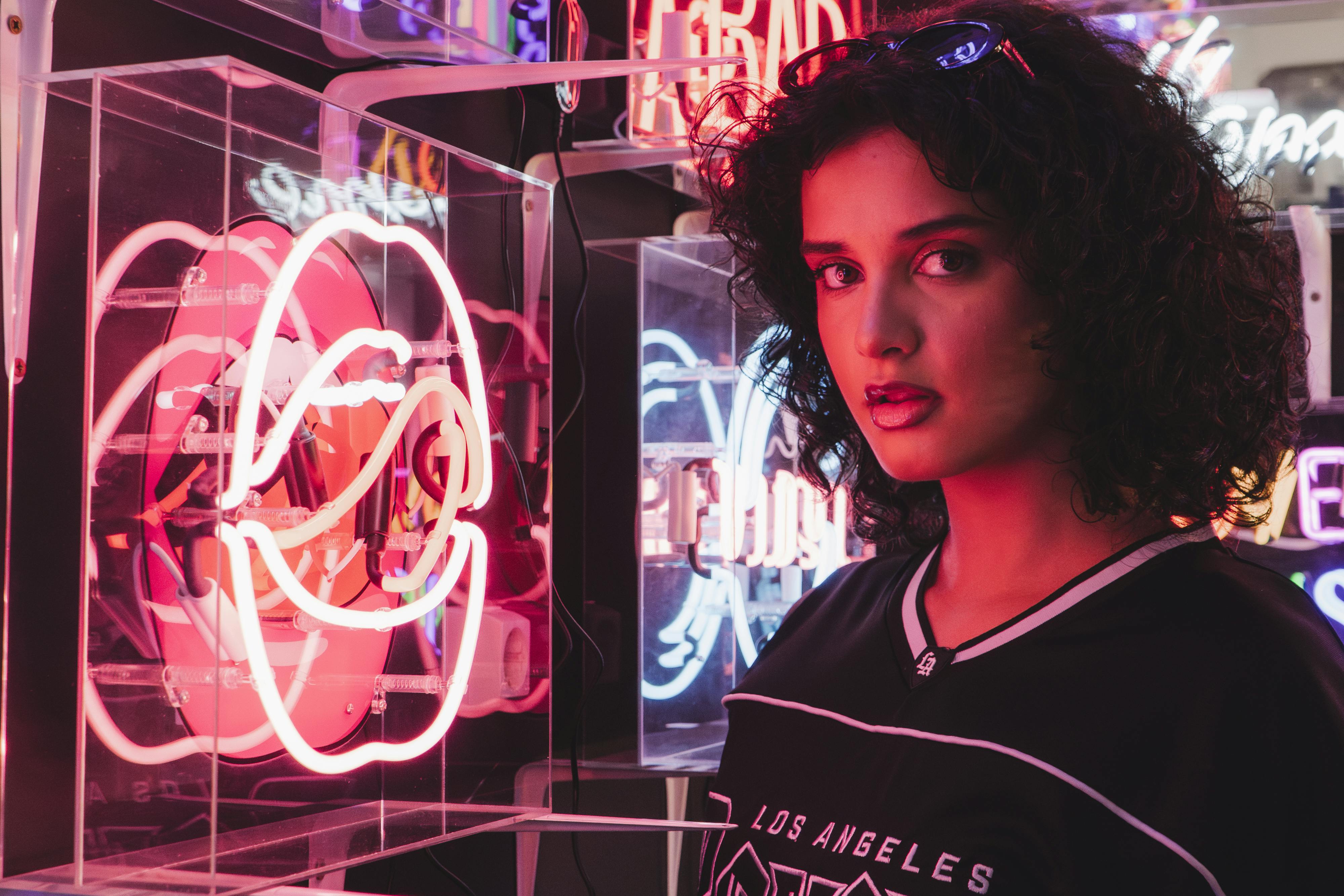 brunette woman near neon light