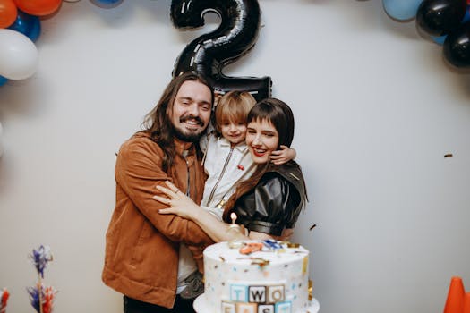 A joyful family celebration for a child's second birthday with balloons and a cake indoors.