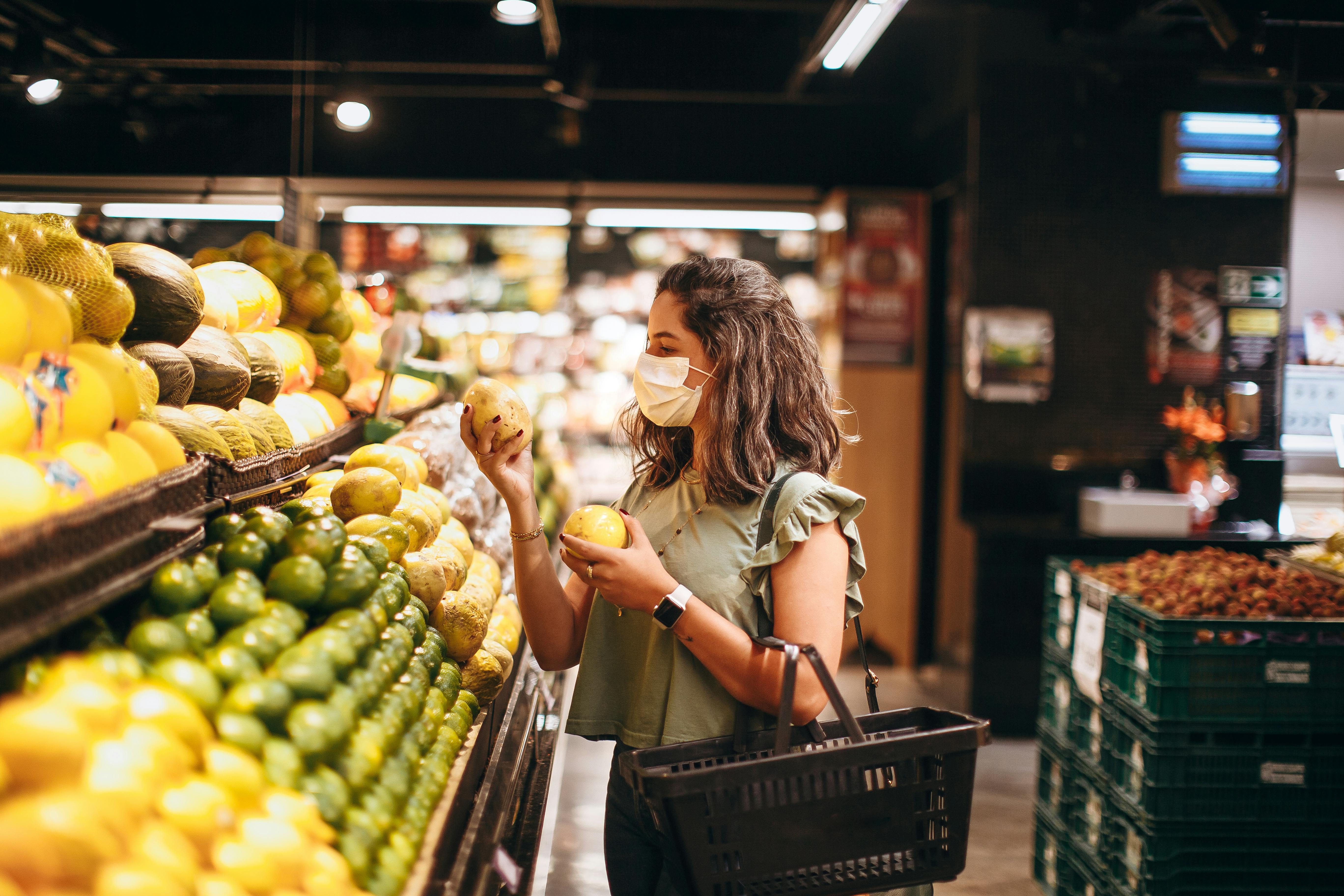 Woman wearing a face mask shopping in a grocery store