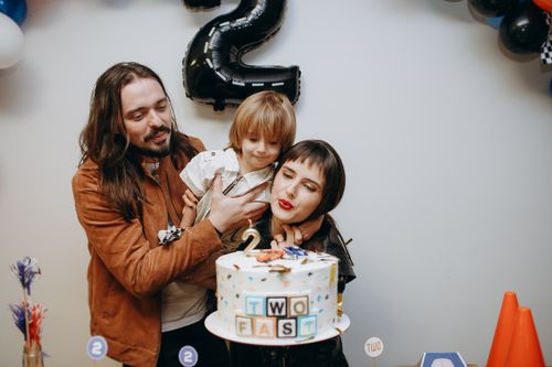 Free A joyful family celebrates their child's second birthday with a themed cake. Stock Photo