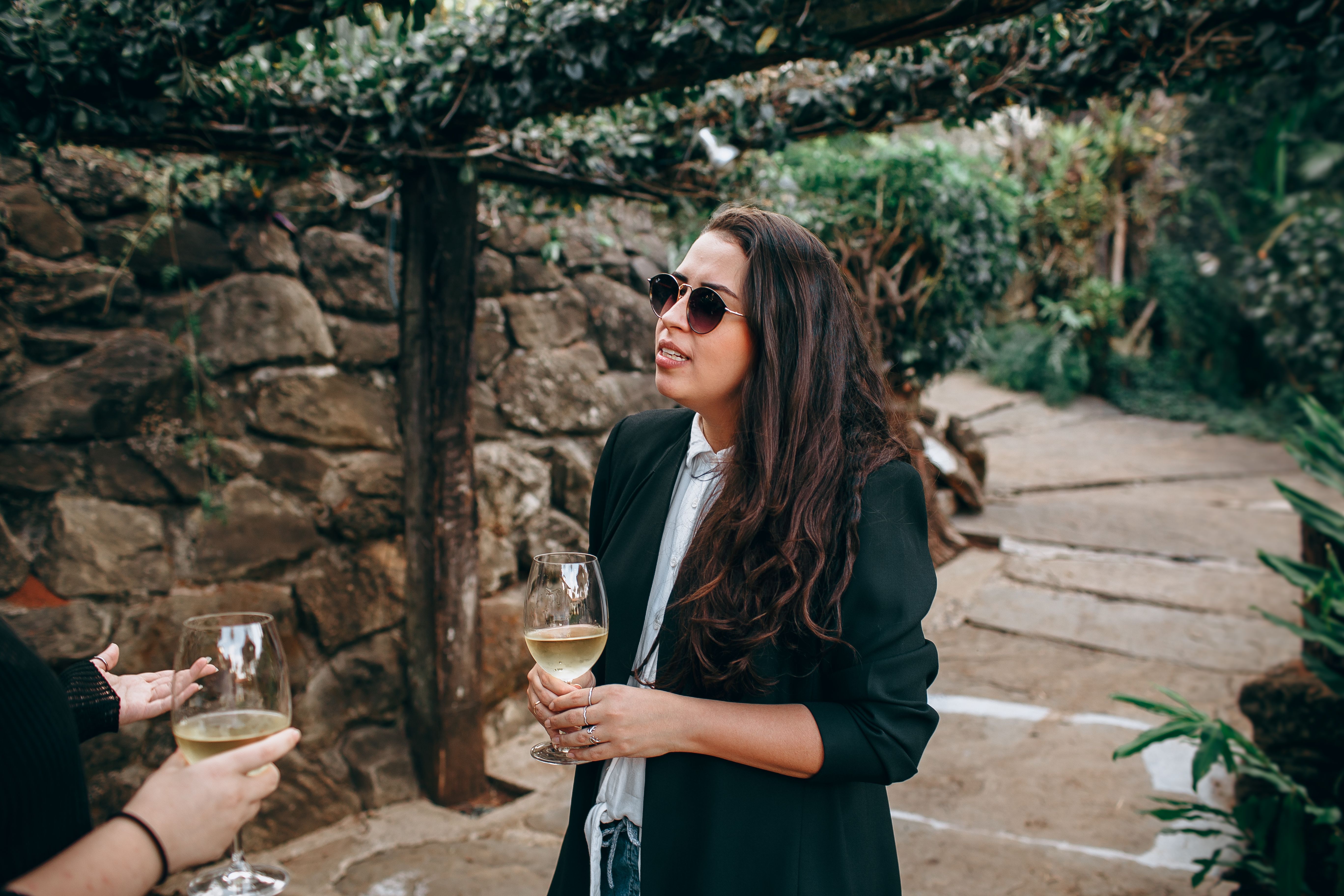 People enjoying a wine tasting at a beautiful vineyard in Stellenbosch, South Africa