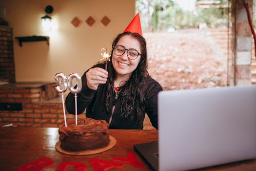 Woman celebrating her 30th birthday with a chocolate cake and online call.