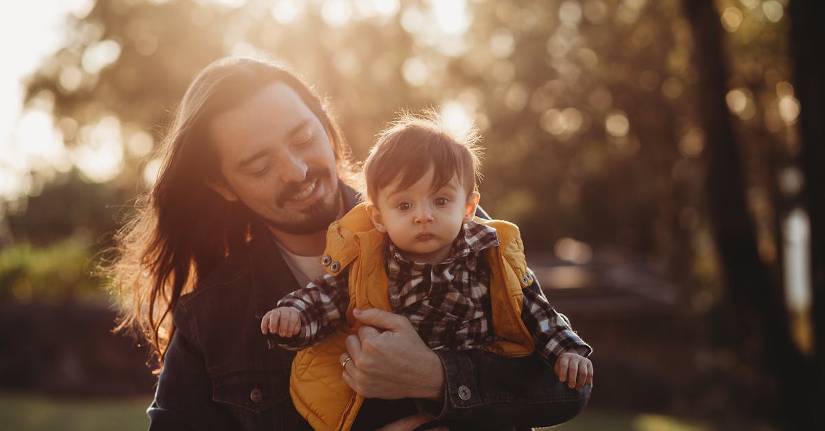 A man holding a baby in the sun