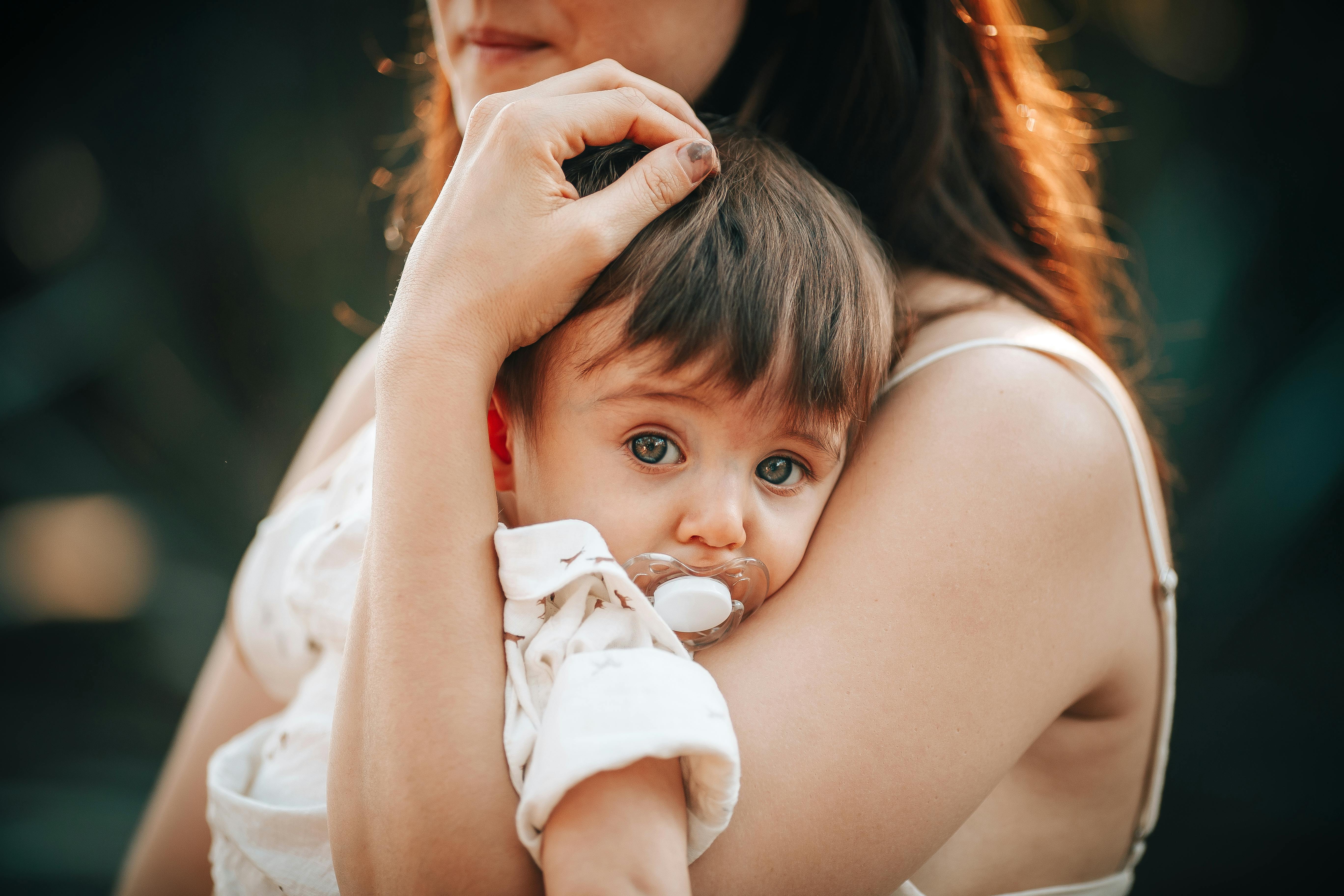 Free Woman Holding a Baby in her Arms  Stock Photo