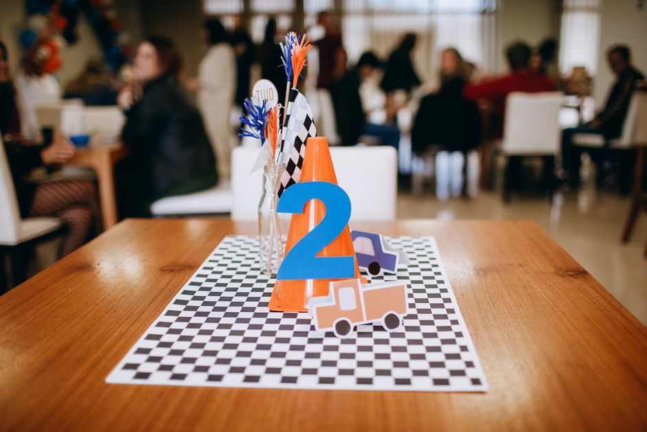Vibrant birthday table setting with race theme decor and number two centerpiece indoors.