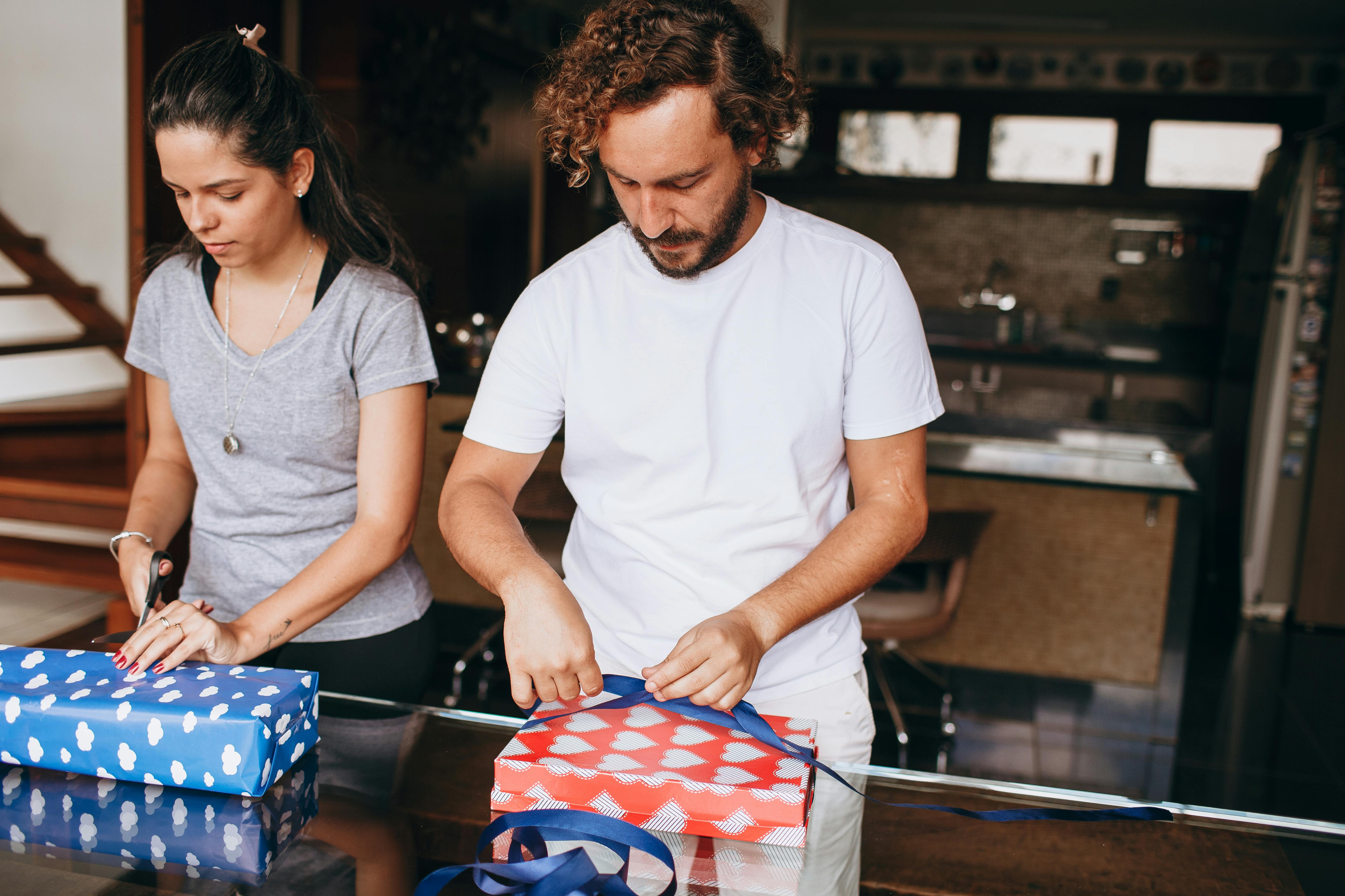 woman and man wrapping gifts