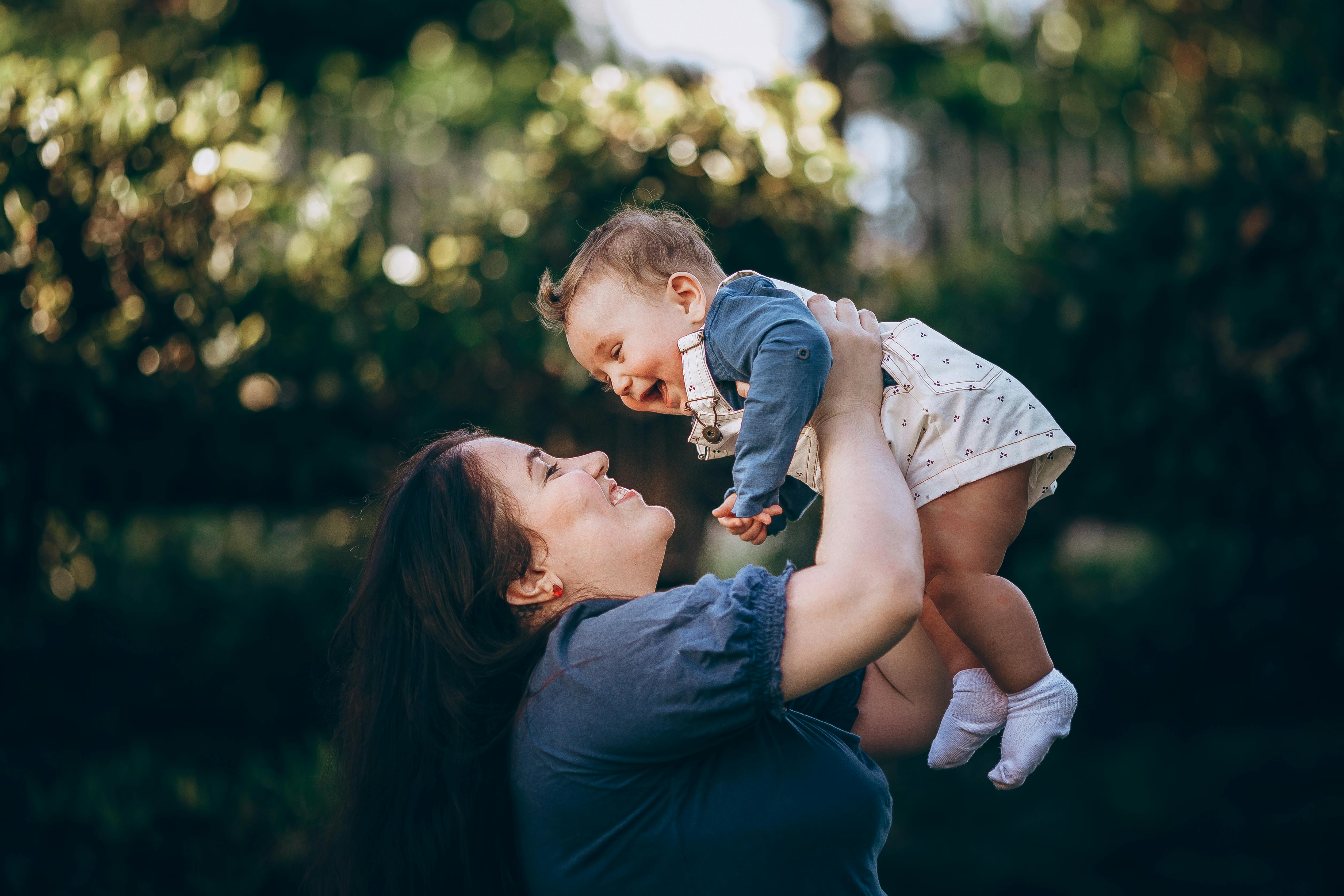 A happy, healthy new mother holding her baby - pregnancy fitness classes near me