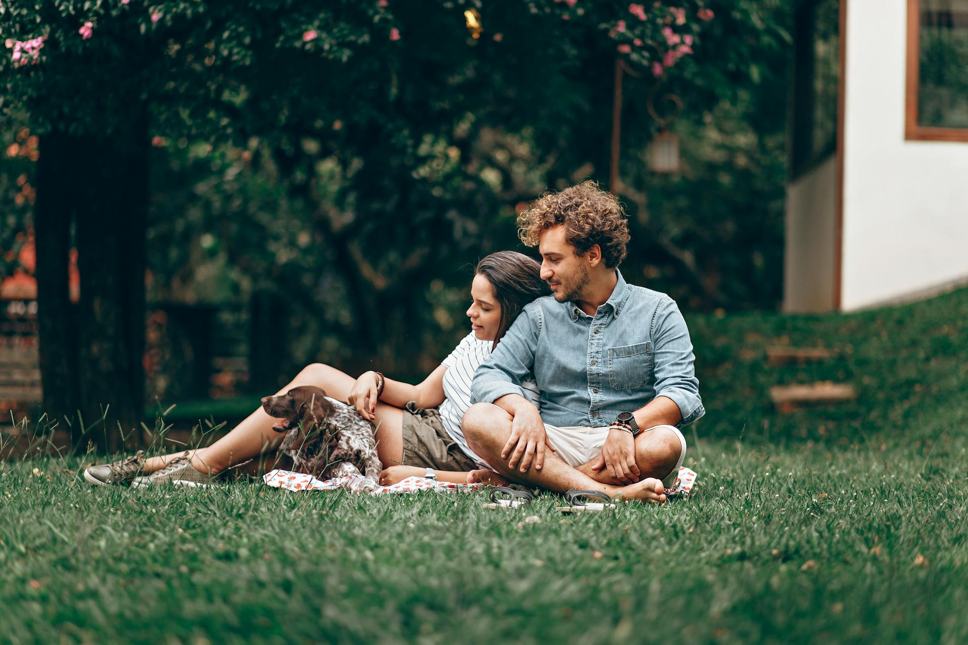 Couple Sitting with Dog at Park