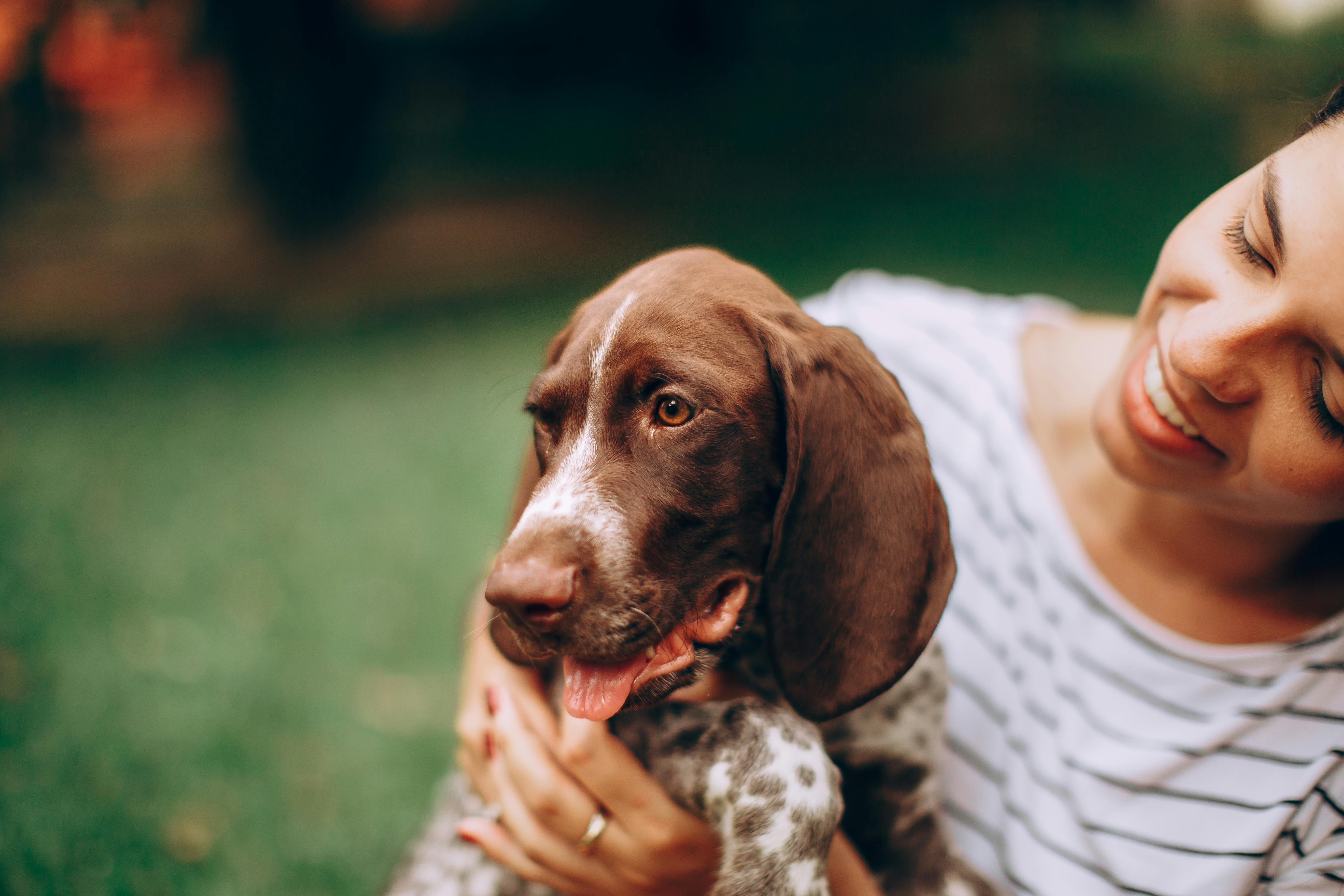 A woman holding a dog in her arms