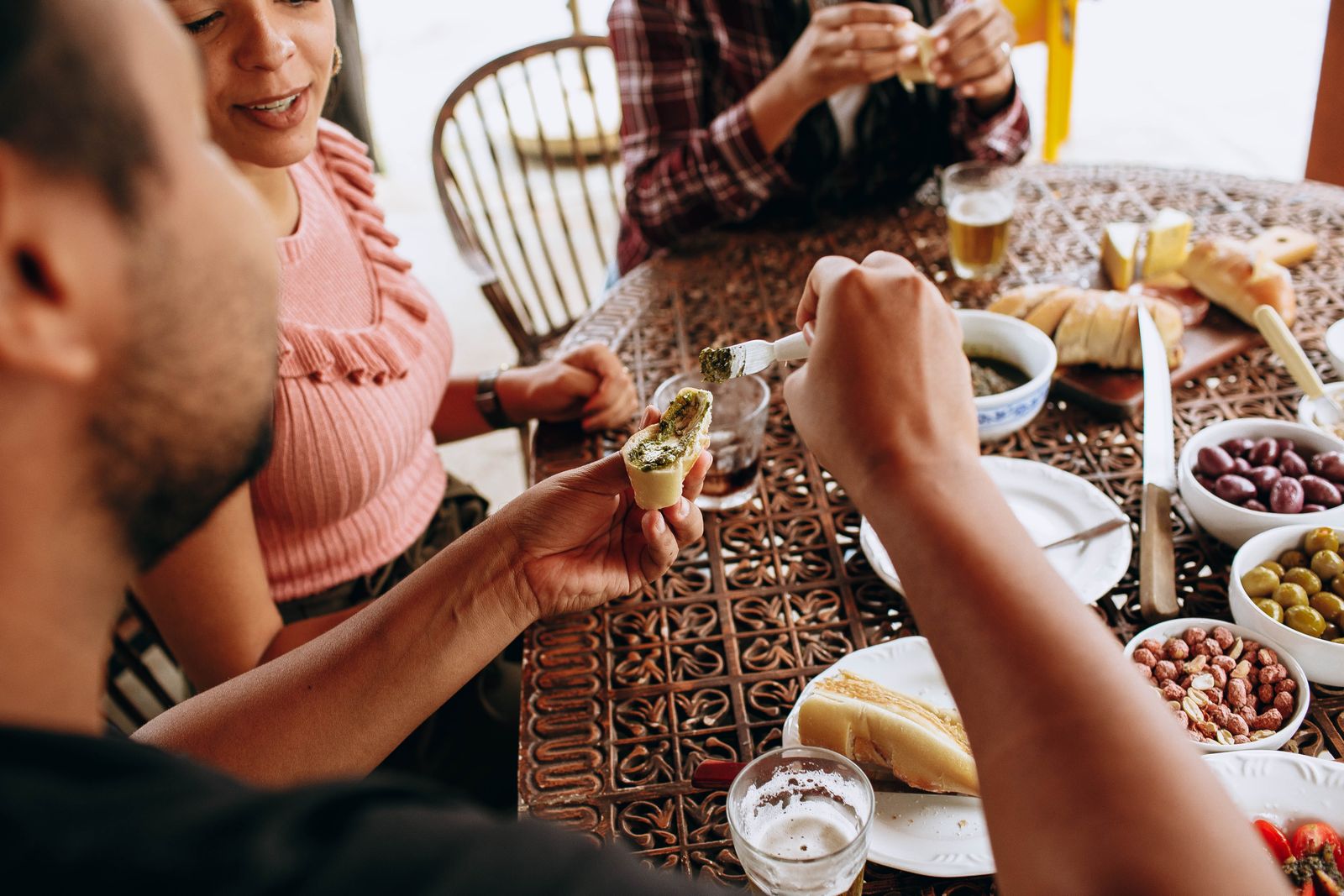 Friends sharing a Mediterranean meal outdoors