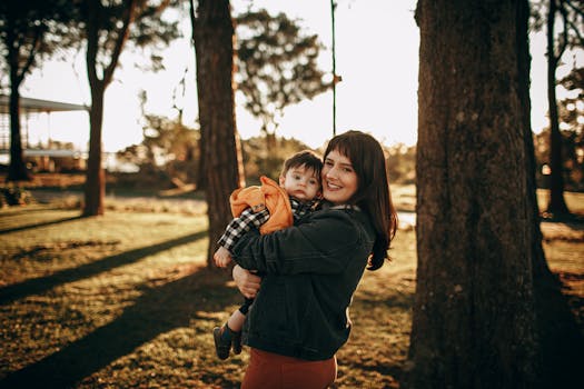 A woman holding a child in the park