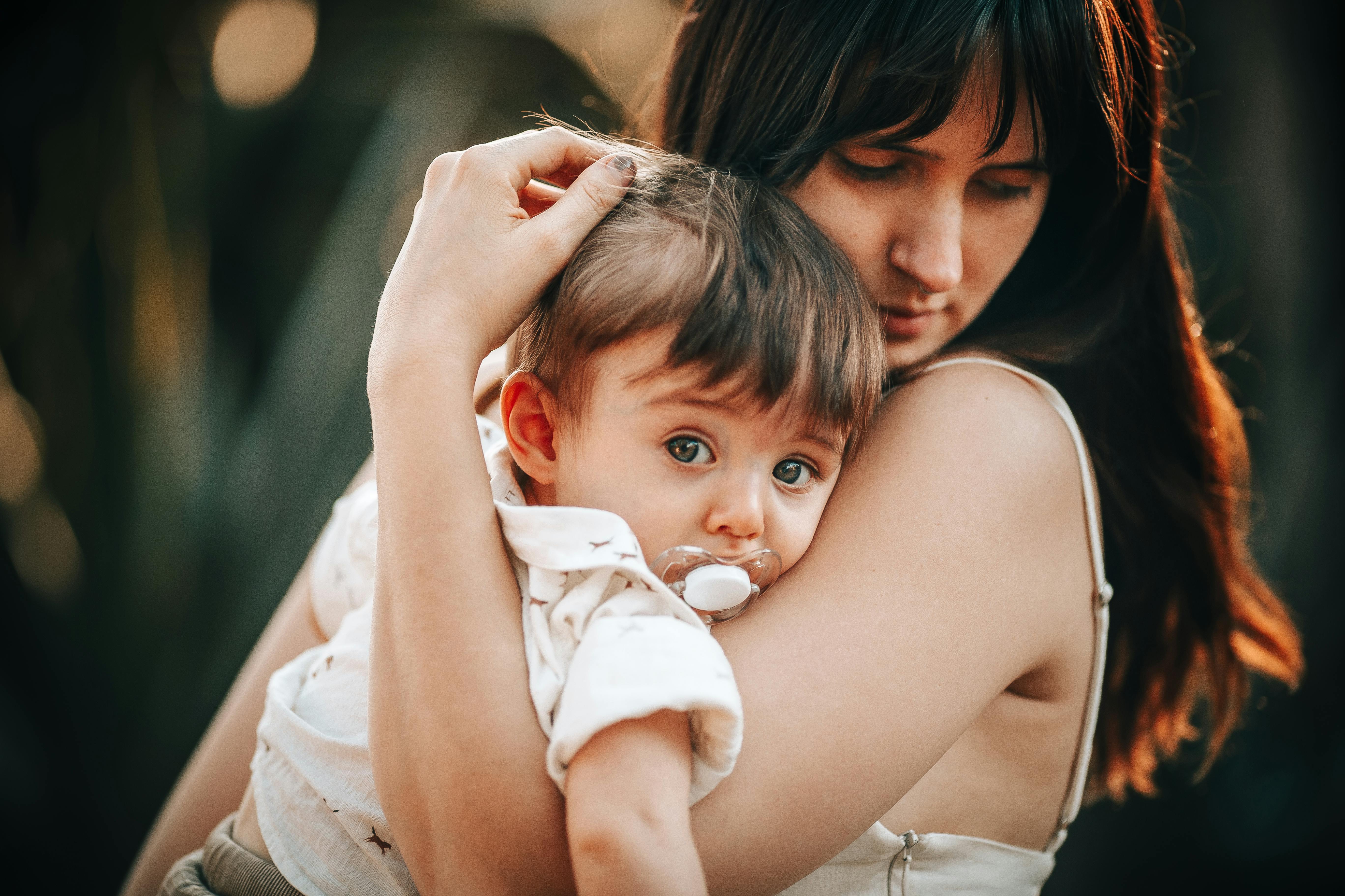 A woman holding a baby in her arms