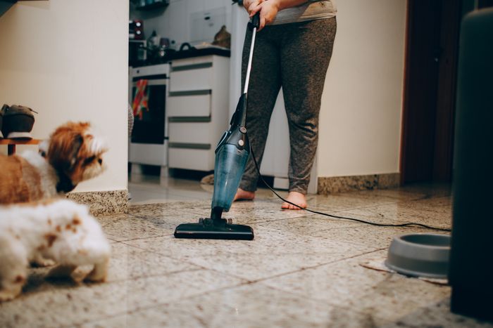 Vacuuming a kitchen floor