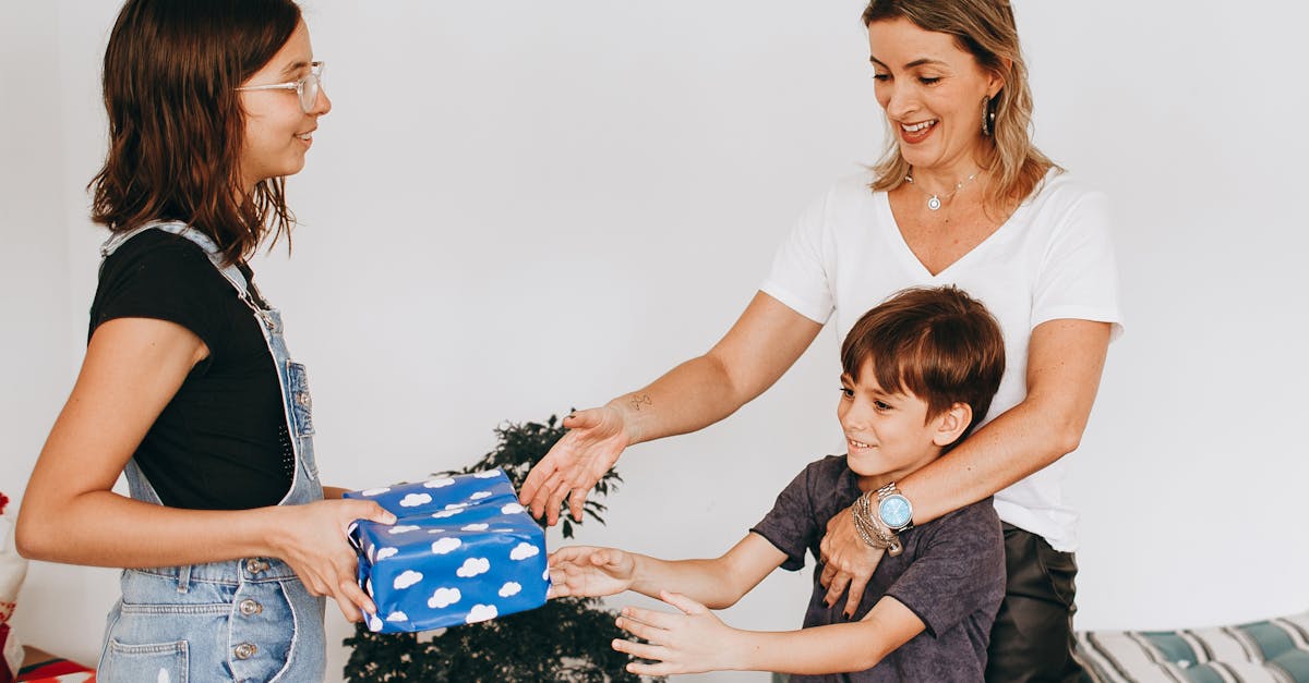 A woman giving a gift to a child