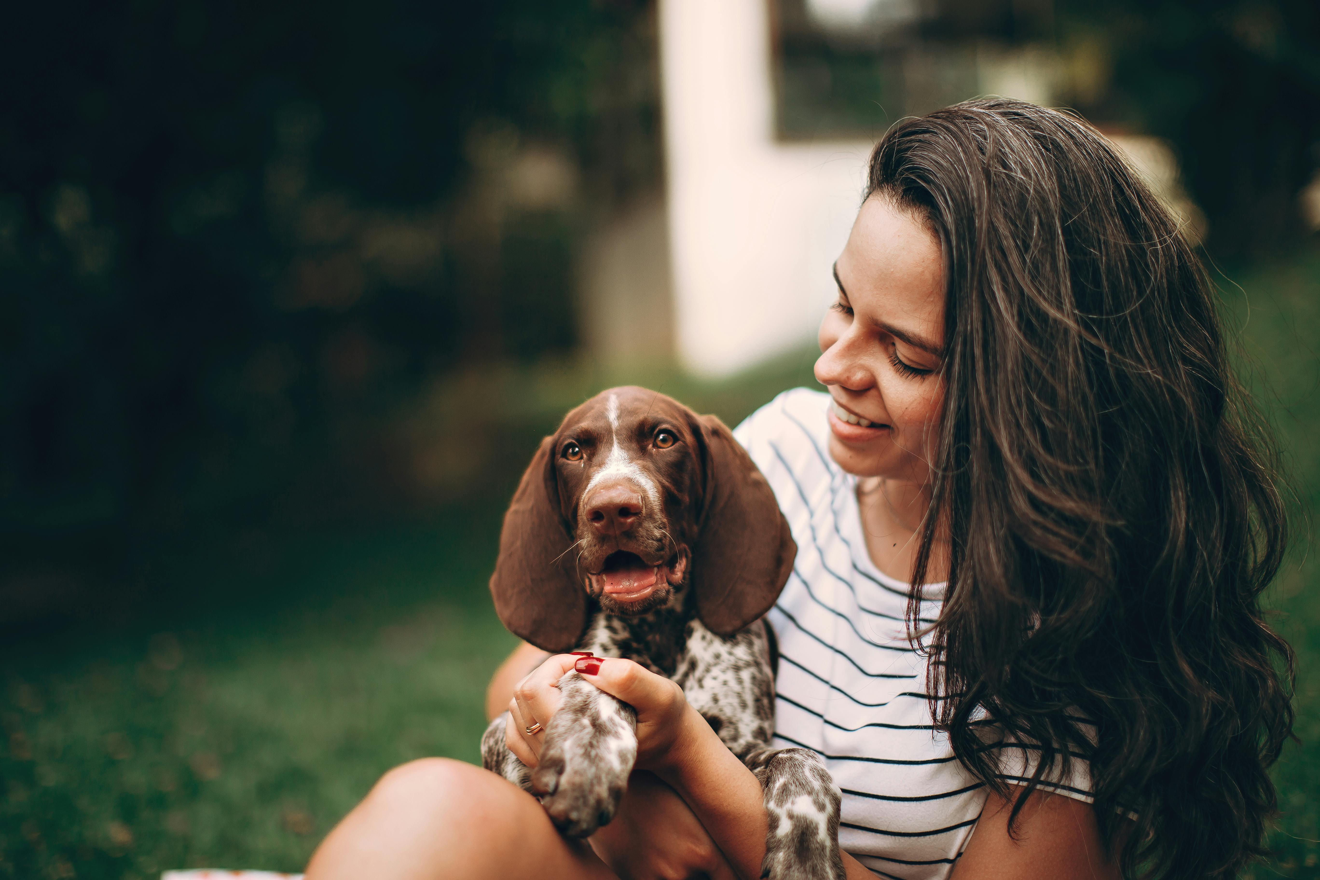 A woman holding a dog in her arms